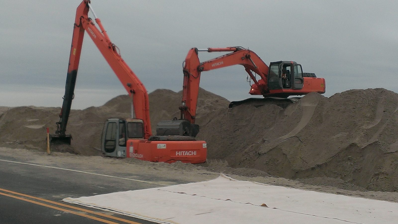 Excavators digging a utility trench on a construction site